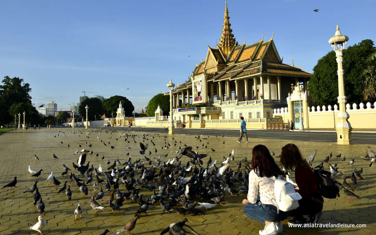 Tourists with pigeons at a square in front of the Royal Palace, Phnom Penh, Cambodia