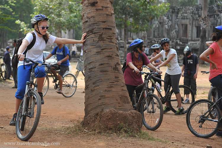 Foreign students riding their bicycles at the Angkor Thom temple, Siem Reap, Cambodia