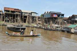 Cambodian man sail on a boat near the fishing village of Tonle Sap Lake, Siem Reap, Cambodia