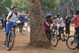 Foreign students riding their bicycles at the Angkor Thom temple, Siem Reap, Cambodia