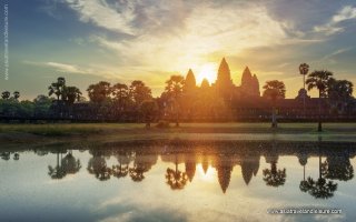 Mysterious towers of ancient temple complex Angkor Wat at sunrise