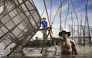 Fisherman fishing on the boat at Tonle Sap lake